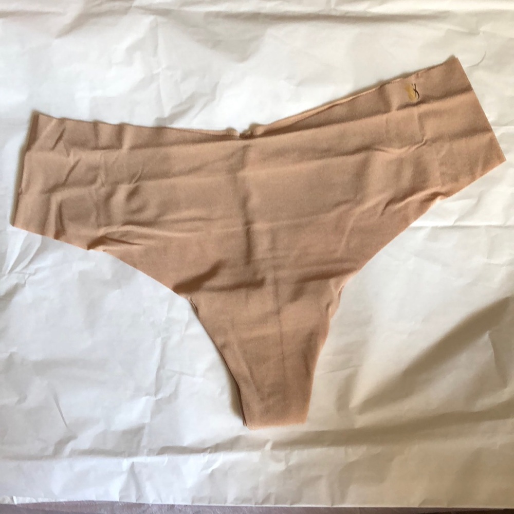 NWOT Victoria’s Secret No Show Thong Panty. Large. Beige color Gold VS logo.